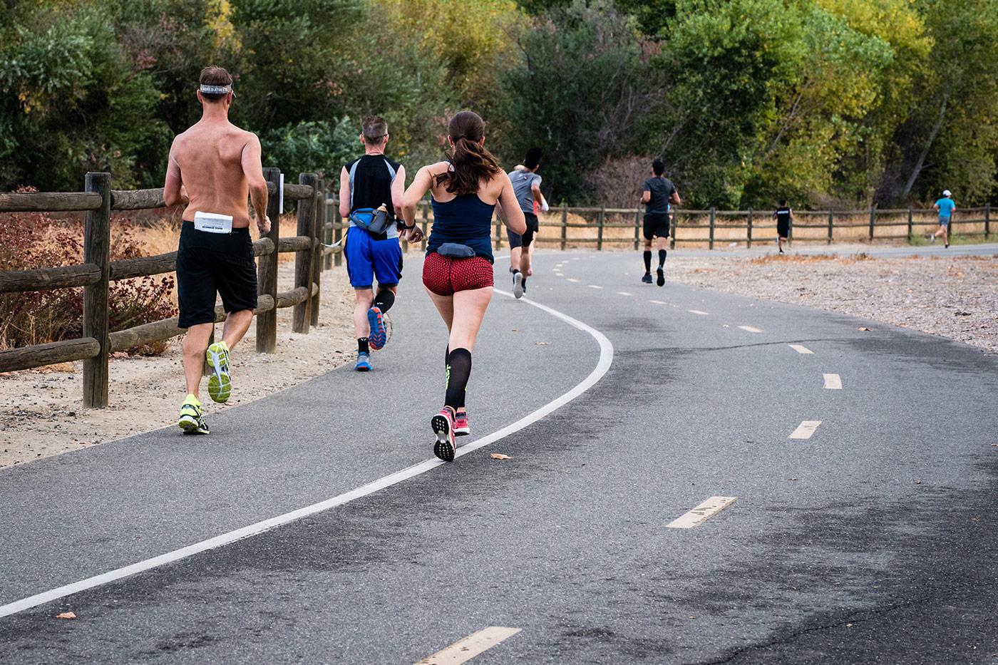 A group of runners running on road
